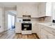 Bright kitchen featuring white cabinets, and a sink, with wood-look floors at 1414 S Post Rd, Shelby, NC 28152