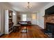 Bright living room featuring a fireplace, hardwood floors, and natural lighting at 1414 S Post Rd, Shelby, NC 28152