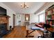 A cozy living room showcases hardwood floors and a brick fireplace with mantle at 1414 S Post Rd, Shelby, NC 28152