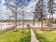 Beautiful waterfront backyard with a well-manicured lawn, a brick path, and a private dock on the lake at 144 Morgan Bluff Rd, Mooresville, NC 28117