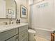 Bright bathroom featuring modern vanity with stone countertop and bathtub-shower combination at 144 Morgan Bluff Rd, Mooresville, NC 28117