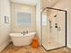 Modern bathroom with soaking tub, glass shower, and stylish wood accent table at 144 Morgan Bluff Rd, Mooresville, NC 28117