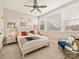 Airy bedroom features a ceiling fan, a plush bed, a cozy chair, and large windows for ample natural light at 144 Morgan Bluff Rd, Mooresville, NC 28117