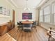 Stylish dining room with a modern light fixture, wainscoting details, hardwood floors, and a large window at 144 Morgan Bluff Rd, Mooresville, NC 28117