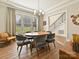 Bright dining area featuring hardwood floors, large windows, modern lighting, and stylish decor at 144 Morgan Bluff Rd, Mooresville, NC 28117