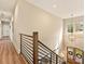 Elegant foyer featuring modern railing, chandelier, and natural light streaming through the front door windows at 144 Morgan Bluff Rd, Mooresville, NC 28117