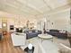 Bright living room with coffered ceilings open to a modern kitchen and complete with gray couches and light colored walls at 144 Morgan Bluff Rd, Mooresville, NC 28117