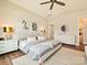 Bright main bedroom featuring luxury vinyl floors, neutral tones, and an en-suite bathroom at 144 Morgan Bluff Rd, Mooresville, NC 28117