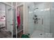 Modern bathroom featuring a frameless glass shower with gray tiling and chrome fixtures at 150 Shields Dr, Lincolnton, NC 28092