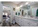 Bright bathroom with double sinks, a large mirror, and a view of the bedroom at 150 Shields Dr, Lincolnton, NC 28092