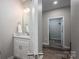 Bathroom with a single sink vanity and a view into the shower through an open doorway at 150 Shields Dr, Lincolnton, NC 28092