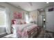 Bright bedroom features a brass bed frame with pink bedding and ample natural light at 150 Shields Dr, Lincolnton, NC 28092