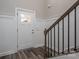 Inviting entryway with white paneling, wood floors, and staircase at 150 Shields Dr, Lincolnton, NC 28092