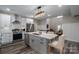 Well-lit, modern kitchen with stainless steel appliances, white cabinets, and a marble island at 150 Shields Dr, Lincolnton, NC 28092