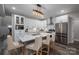 Bright kitchen featuring a marble-topped island, stainless steel appliances, and modern lighting at 150 Shields Dr, Lincolnton, NC 28092