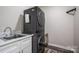 A compact laundry room with stacked washer/dryer units and a utility sink at 150 Shields Dr, Lincolnton, NC 28092