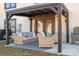 Inviting patio with cozy wicker furniture under a pergola with string lights and access to the home at 150 Shields Dr, Lincolnton, NC 28092