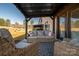 Inviting patio with cozy wicker furniture under a pergola with string lights and views of the yard at 150 Shields Dr, Lincolnton, NC 28092