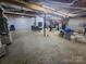 Unfinished basement with concrete floors and exposed ductwork, offering potential for customization at 155 Rivercliff Dr, Stony Point, NC 28678