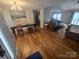 Bright living room and dining area featuring beautiful wood floors and a picturesque painting at 155 Rivercliff Dr, Stony Point, NC 28678