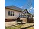 Outdoor deck and patio with a bench swing provide a relaxing space to enjoy the backyard at 1640 Winthrop Ln, Monroe, NC 28110