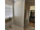 Well-lit bathroom with black and white tiled floors, and a walk-in shower leading to a closet at 1640 Winthrop Ln, Monroe, NC 28110