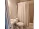 Well-lit bathroom with a tub and shower combo, classic white fixtures, and a pedestal sink at 1640 Winthrop Ln, Monroe, NC 28110