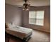 Cozy bedroom featuring carpeted floors, a ceiling fan, and a bright window at 1640 Winthrop Ln, Monroe, NC 28110