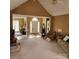 Inviting living room with vaulted ceilings, neutral carpet, and a view into the foyer at 1640 Winthrop Ln, Monroe, NC 28110