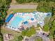 Aerial view of the community pool with various pool types, lounge areas, and a playground at 17201 Royal Court Dr, Davidson, NC 28036