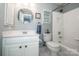 Bright bathroom featuring a vanity with ample storage, an octagon mirror, and a shower over tub at 17201 Royal Court Dr, Davidson, NC 28036