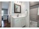 Bright bathroom with white vanity, framed mirror, and shower over tub at 17201 Royal Court Dr, Davidson, NC 28036