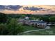 Elegant clubhouse exterior featuring a covered patio, lush landscaping, and inviting architectural details at sunset at 17201 Royal Court Dr, Davidson, NC 28036