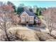 Beautiful two-story brick home featuring manicured landscaping, circular driveway, and mature trees at 17201 Royal Court Dr, Davidson, NC 28036