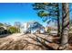 View of backyard, deck, and three-car garage at 17201 Royal Court Dr, Davidson, NC 28036