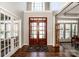 Foyer with hardwood floors, entry doors, and view of dining area at 17201 Royal Court Dr, Davidson, NC 28036