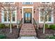 Inviting entryway with brick steps, black iron railings, and stylish outdoor lighting at 17201 Royal Court Dr, Davidson, NC 28036