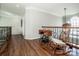 Upstairs hallway features hardwood floors, wood banister, and lots of natural light at 17201 Royal Court Dr, Davidson, NC 28036