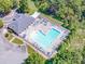 Aerial view of a community pool with ample lounge chairs and tables surrounded by mature trees at 17201 Royal Court Dr, Davidson, NC 28036