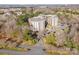 Well-maintained condominium building surrounded by mature trees and landscaping with a circular driveway at 211 Heritage Blvd # 612, Fort Mill, SC 29715