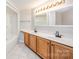 A bathroom featuring a large vanity with double sinks and white tiled floors at 211 Heritage Blvd # 612, Fort Mill, SC 29715