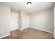 A bedroom featuring neutral carpeting, a ceiling light, and a double door closet at 211 Heritage Blvd # 612, Fort Mill, SC 29715