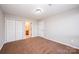 This bedroom features neutral carpeting, a ceiling light, and a double door closet at 211 Heritage Blvd # 612, Fort Mill, SC 29715