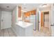 A well-lit kitchen with wood cabinets, white countertops, and tile flooring near a laundry room at 211 Heritage Blvd # 612, Fort Mill, SC 29715