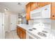 Cozy kitchen with wood cabinets, white appliances, tile flooring and a view of the living room at 211 Heritage Blvd # 612, Fort Mill, SC 29715