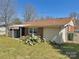 Backyard view featuring a brick and siding home, covered patio, and established cactus garden at 2210 Milton Rd, Charlotte, NC 28215