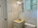 Cozy bathroom features a toilet, a vanity sink with cabinet, and a mirrored medicine cabinet at 2210 Milton Rd, Charlotte, NC 28215