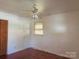 Bedroom with hardwood floors, ceiling fan, window, and closet doors at 2210 Milton Rd, Charlotte, NC 28215