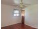 Bedroom with hardwood floors, ceiling fan, window, and closet door at 2210 Milton Rd, Charlotte, NC 28215