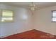 Bedroom with hardwood floors, ceiling fan, and natural light from two windows at 2210 Milton Rd, Charlotte, NC 28215